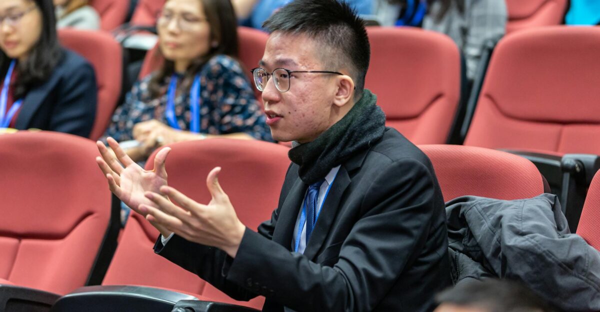 Students actively participating in a university lecture discussing and engaging