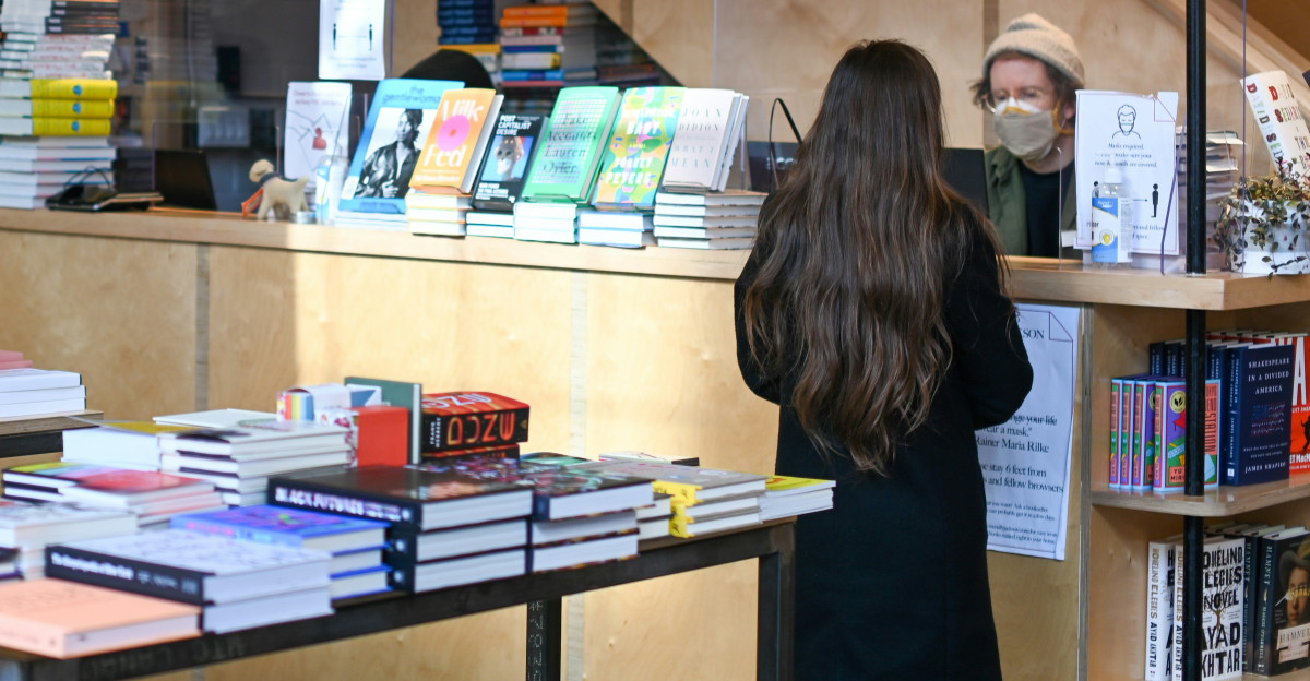 woman in black shirt standing near brown wooden table