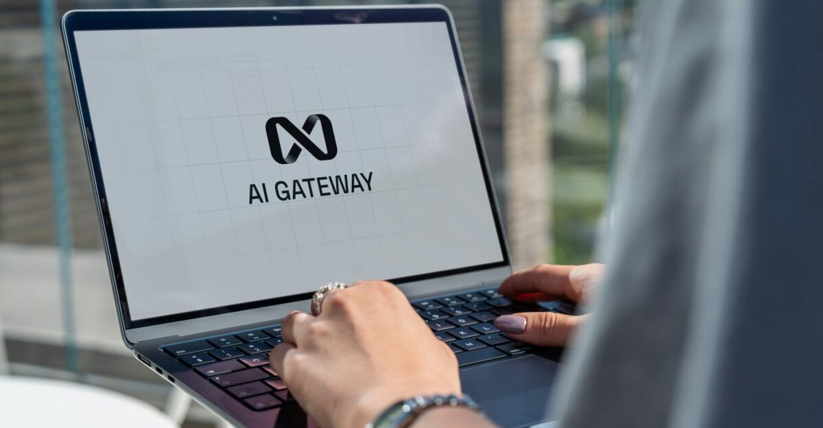 Person typing on laptop with ai gateway logo