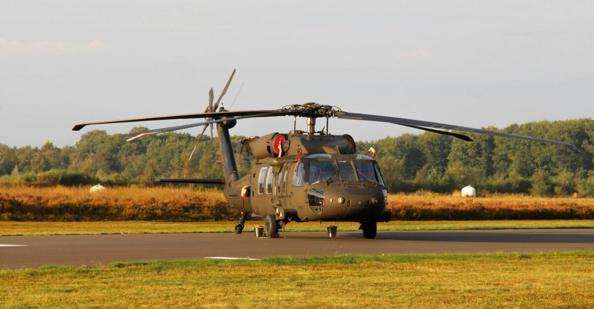 A helicopter sitting on top of an airport runway