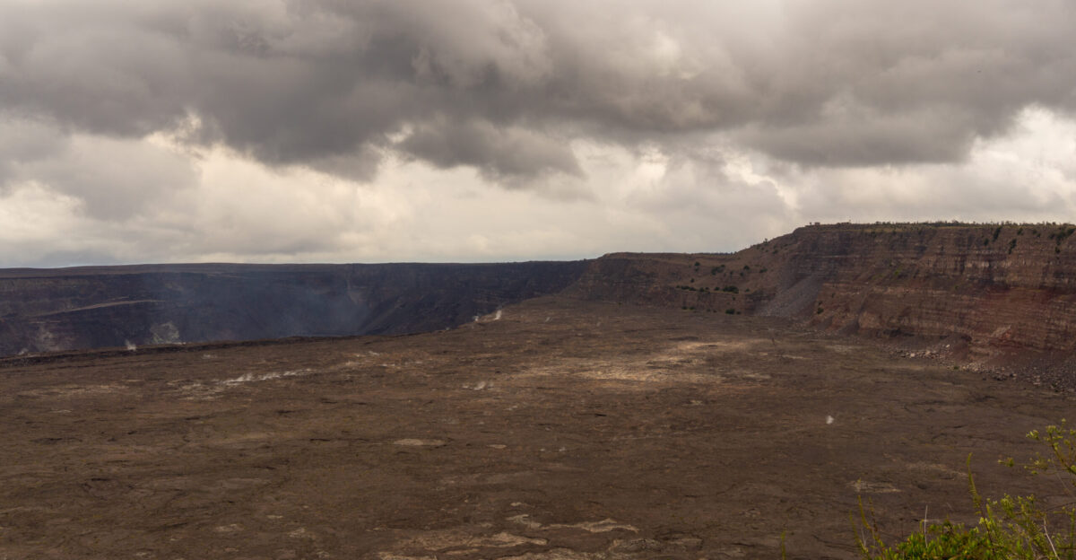 Summit of K lauea steaming Halema uma u crater in the distance Photo is taken in 2019 a year after 2018 activity that has seen the caldera floor drop significantly Jaggar museum and overlook seen on the hillside closed because of unstable ground