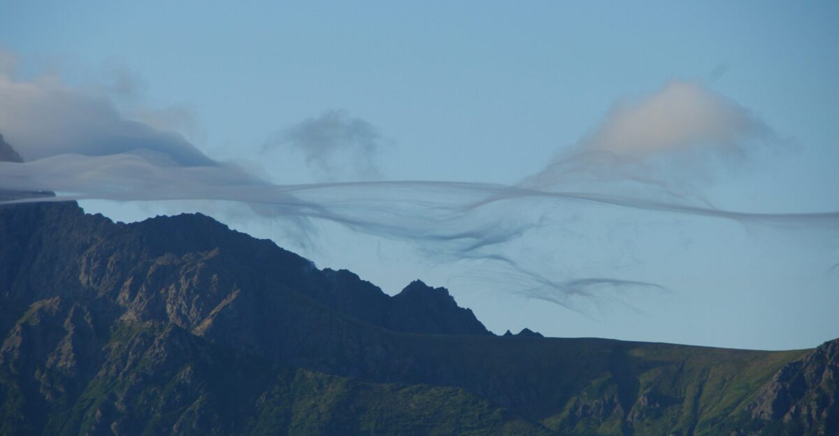 brown and green mountains under white clouds during daytime