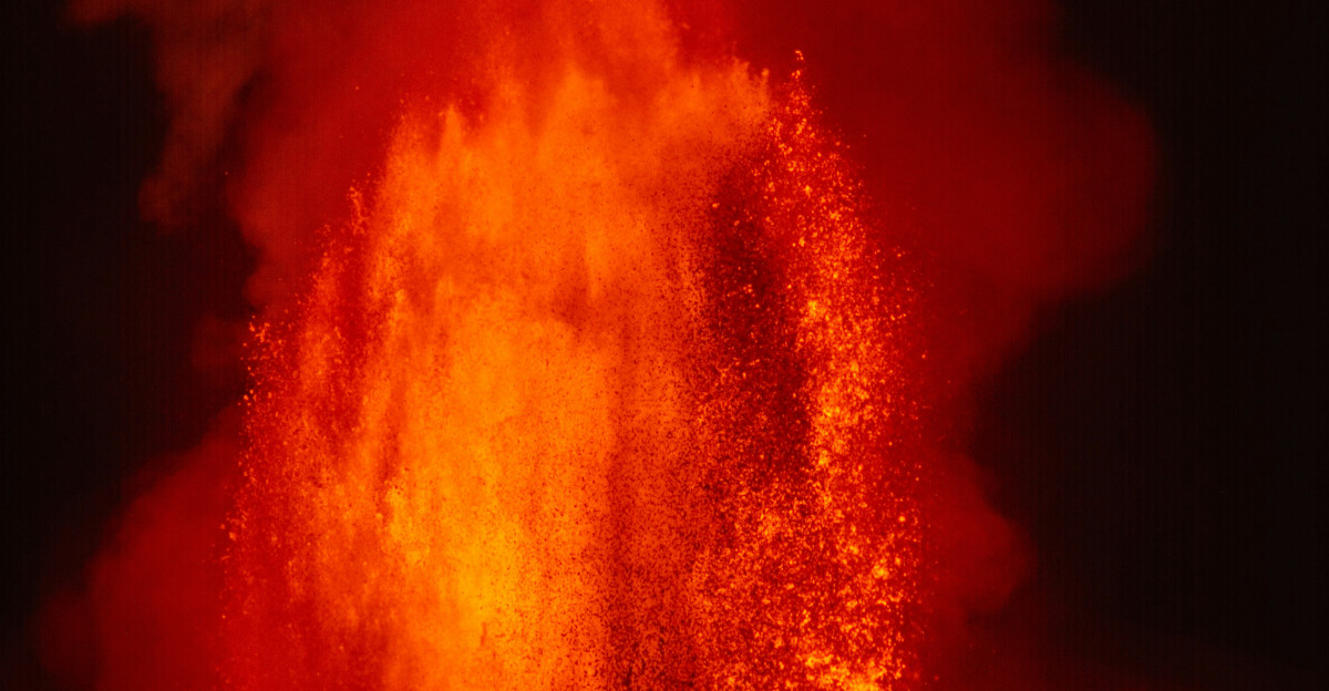 Volcano erupting with molten lava and smoke